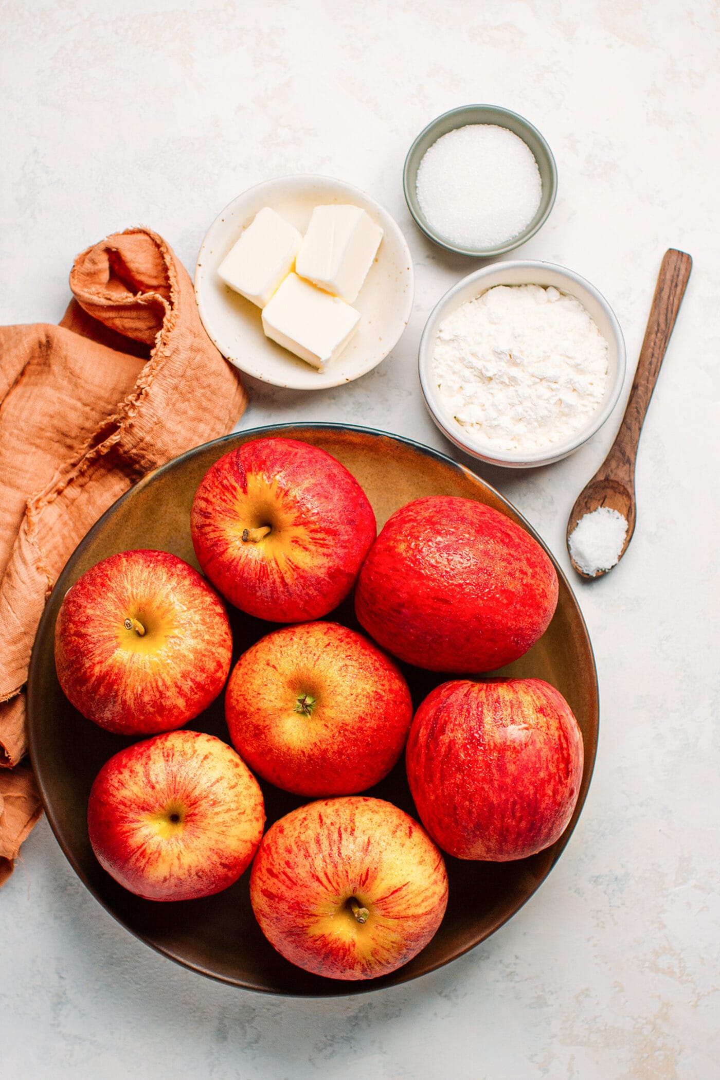 Ingredients like apples, flour, butter, and sugar.